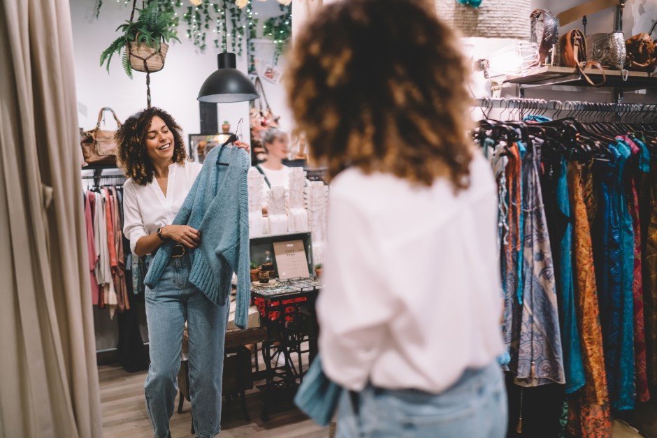 Woman thrift shopping for clothes at SHE'que Thrift Boutique supporting domestic violence programmes at SHE Casa Foundation